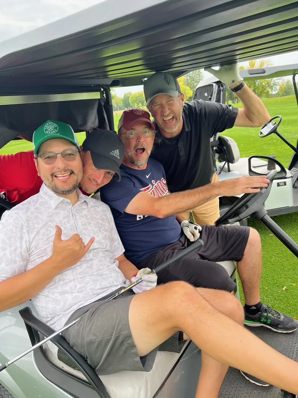 Players clowning around on a golf cart